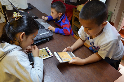 タブレットとパソコンを使って対局するメキシコの子供達
